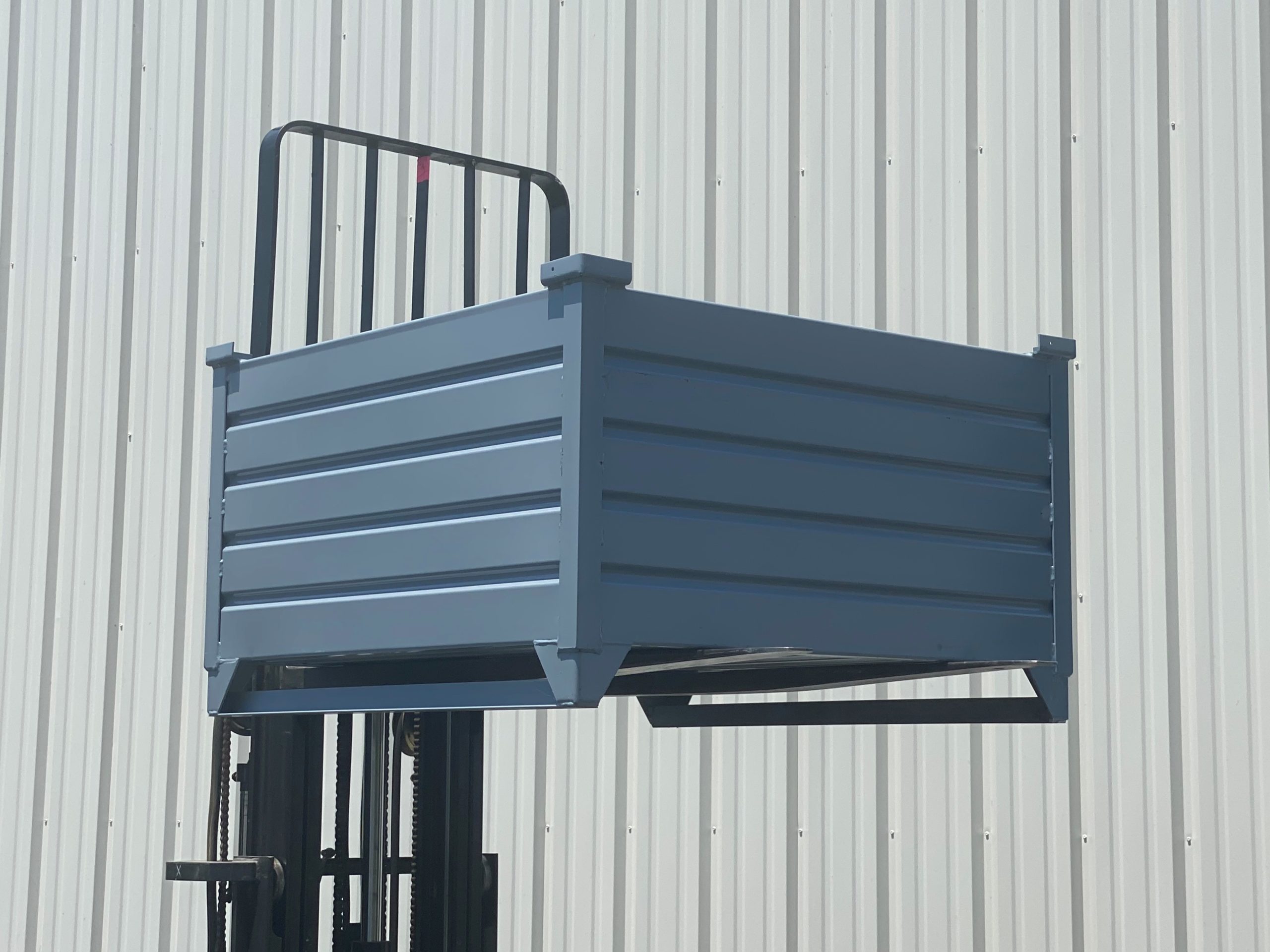 https://rackandshelf.com/wp-content/uploads/Corrugated-Steel-Container-with-Runners-Lifted-1-scaled.jpg