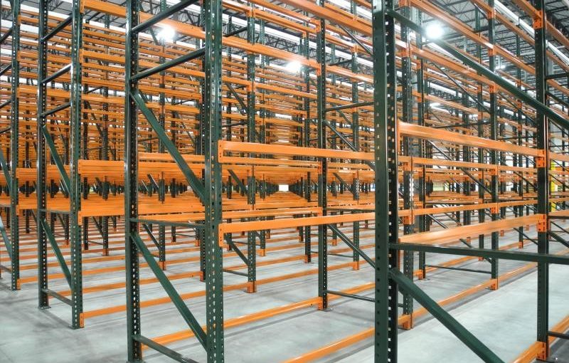 What is the history of the pallet rack and how was it designed to be used in warehousing of palletized products?